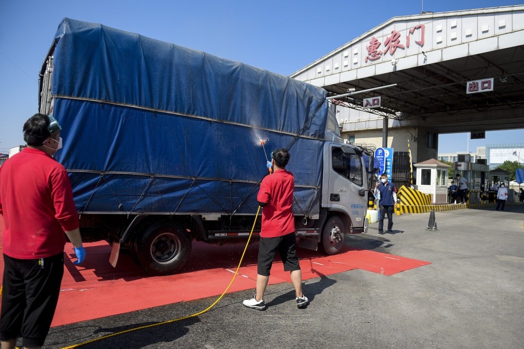 Staff disinfect a vehicle leaving the Xinfadi market in Fengtai district in Beijing on Tuesday. Photo: Xinhua