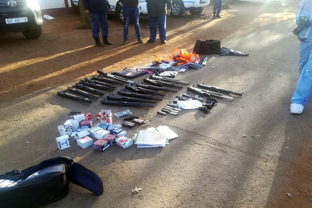 Confiscated arms and ammunition, lay on the ground at a church in Zuurbekom, near Johannesburg. Photo: South African Police Services via AP