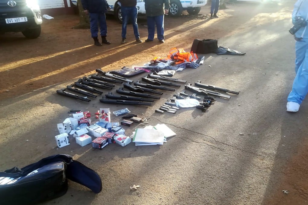 Confiscated arms and ammunition, lay on the ground at a church in Zuurbekom, near Johannesburg. Photo: South African Police Services via AP