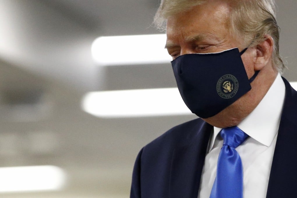 President Donald Trump wears a face mask as he walks down a hallway during a visit to Walter Reed National Military Medical Centre in Bethesda. Photo: AP Photo
