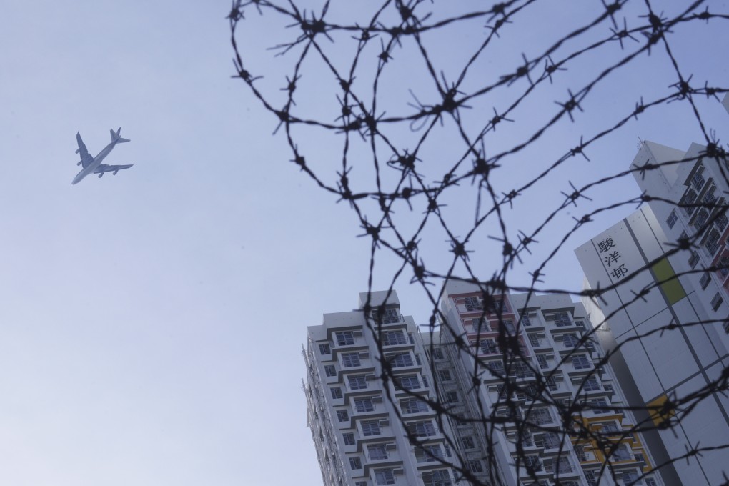 A plane flies over the government quarantine camp at Chun Yeung Estate in Fo Tan. Photo: Winson Wong