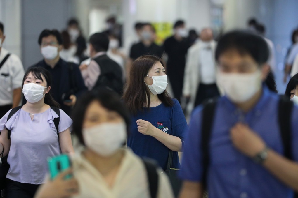 Commuters wearing face masks walk through Tokyo’s Shinjuku station. Photo: Xinhua