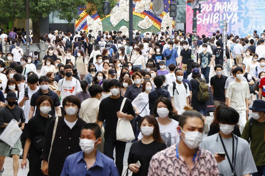 People wearing face masks walk in Tokyo’s Shibuya area. The number of coronavirus cases globally closed in on 13 million on Monday. Photo: Kyodo