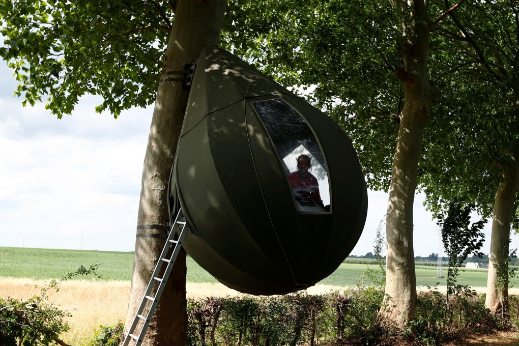 Some Belgians are staying in tents designed by Dutch artist Dre Wapenaar that hang down from trees and cost US$79 a night rather than travel abroad. Photo: Reuters