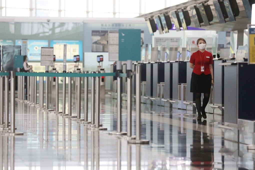 A Cathay Pacific staff member walks past the airlines' check in counter at terminal 1 of the Hong Kong International Airport in Chek Lap Kok in June 2020. The airline industry has continued to suffer from travel restrictions, border closures and quarantine measures to contain the Covid-19 pandemic. Photo: Sam Tsang