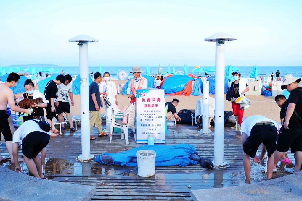 Tourists enjoy a free foot washing service in Huaian, Jiangsu province, China. Some countries are hopeful that by promoting staycations, they can keep their tourism industries alive until the pandemic is over. Photo: Barcroft Media via Getty Images