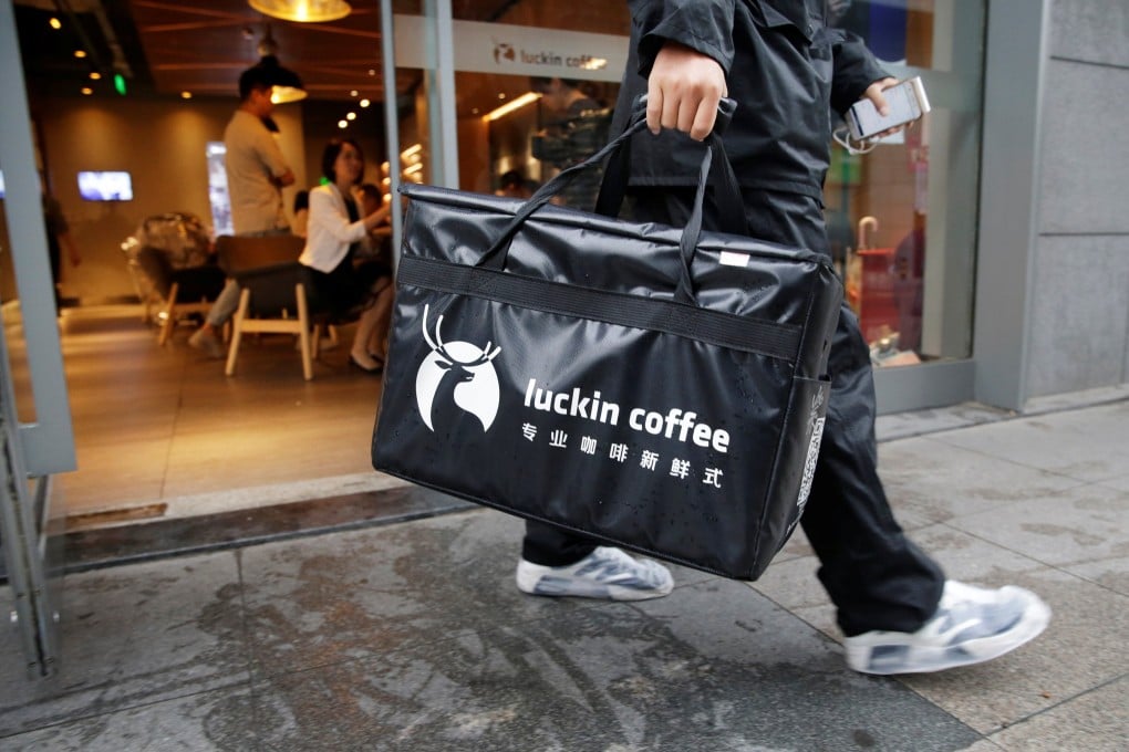 A delivery man leaves a Luckin Coffee outlet in Beijing. The coffee chain is preparing to be delisted from Nasdaq after an accounting scandal. Photo: Reuters