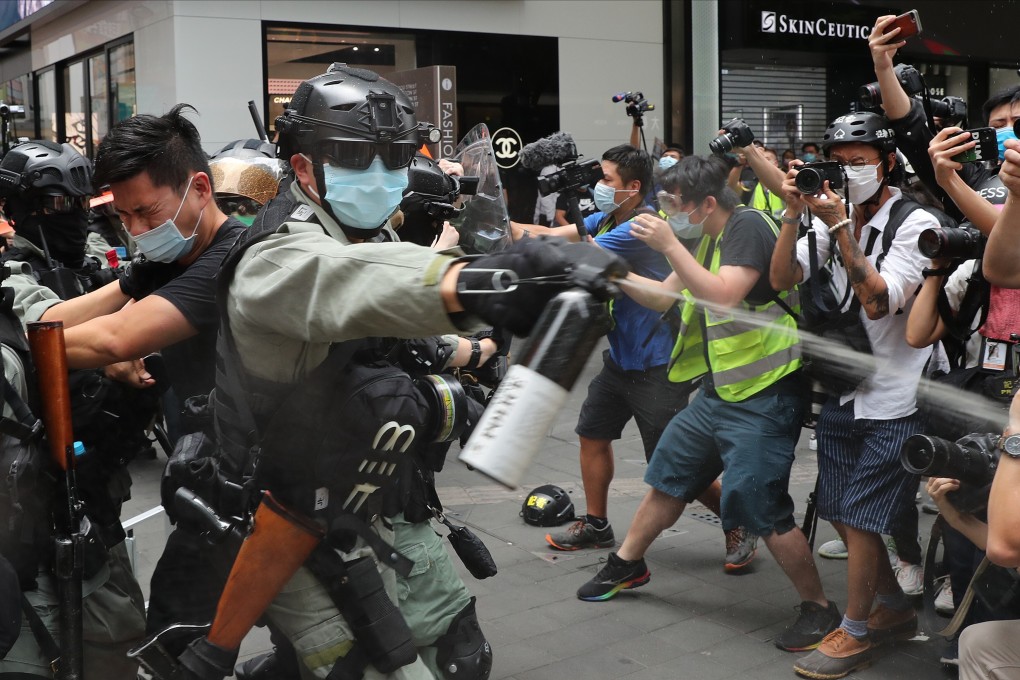 A police officer shoots pepper spray at protesters during a demonstration in Causeway Bay on July 1, the 23rd anniversary of the establishment of the Hong Kong Special Administrative Region. Photo: Sam Tsang
