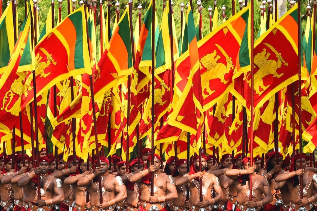Sri Lankan military personnel march in traditional dress holding national flags during the country’s independence day in February 4. Photo: AFP