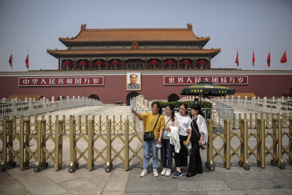 Tourists take a selfie in front of the Tiananmen Gate in Beijing. China is loosening up nationwide travel restrictions after months of lockdown over the coronavirus crisis. Photo: EPA-EFE