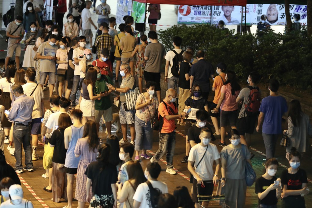 Voters queue outside a polling station on the second and final day of Hong Kong's opposition primary on Sunday. Photo: dpa