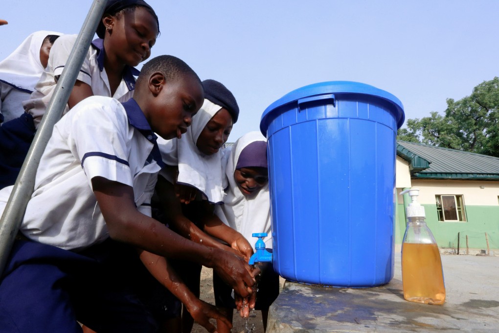 School pupils wash their hands from a bucket in Abuja. Nigeria’s population is expected to expand to almost 800 million in 2100, while over 20 countries will see their populations halve by then, a study has predicted. Photo: Reuters