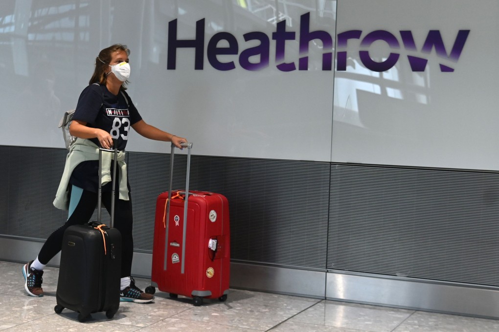 A passenger arrives at London Heathrow. The airport is taking measures to disinfect surfaces and retrain workers as “hygiene technicians” to reduce the risk of Covid-19 infections. Photo: AFP