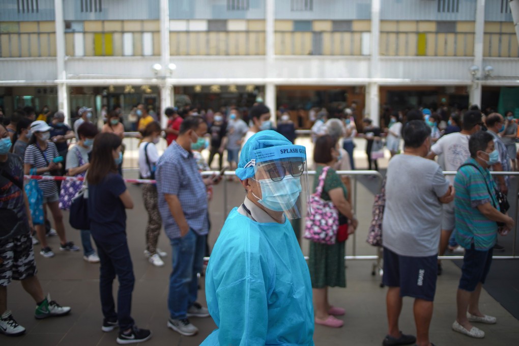 Residents of Ping Shek Estate queue up to submit a saliva sample for testing on July 7 after an employee of a congee shop tested positive for Covid-19. Photo: Winson Wong