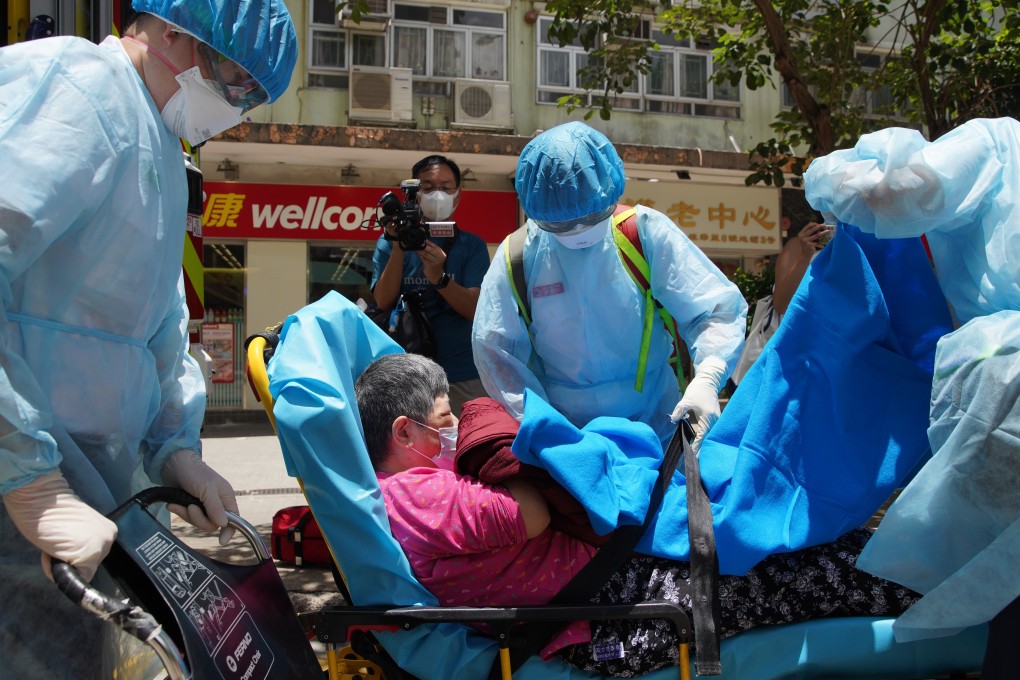 Medical workers with an elderly woman suspected of having Covid-19 outside the Kong Tai Care for the Aged Centre in Hong Kong’s Tsz Wan Shan area. Photo: Winson Wong