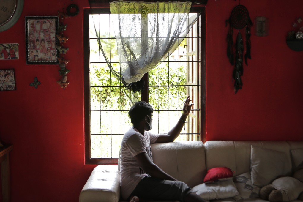 Prasad Dinesh sits in his house in Ja-Ela, Sri Lanka. Photo: AP