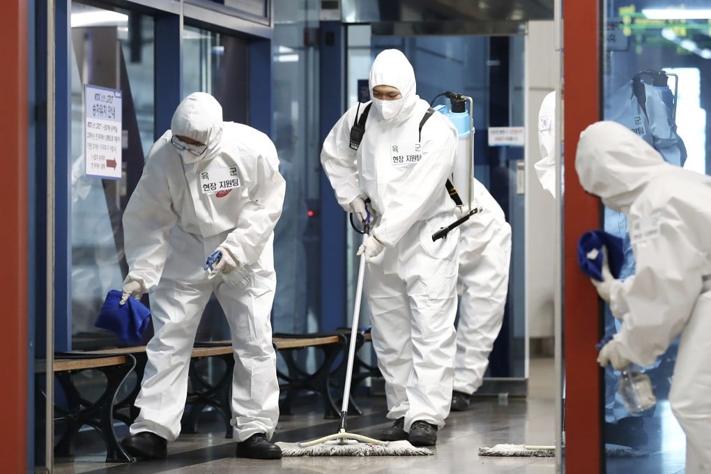 South Korean soldiers wearing protective gears disinfect a train station in Daejeon. Photo: AP