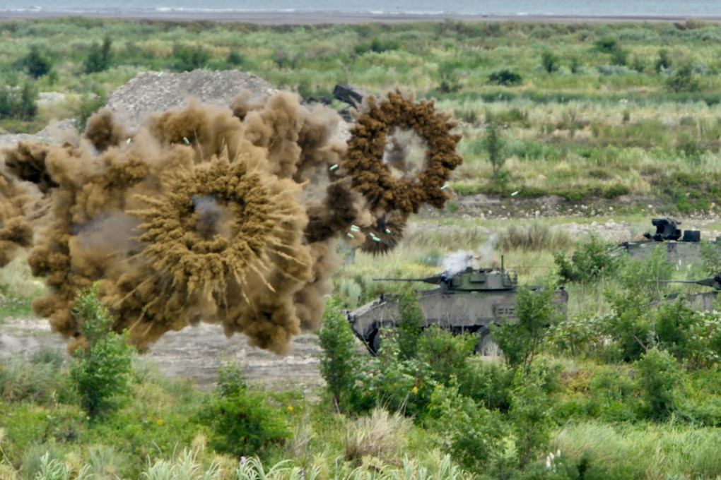 Two armoured vehicles launch smoke grenades during the annual Han Kuang military drills on Thursday. Photo: AFP