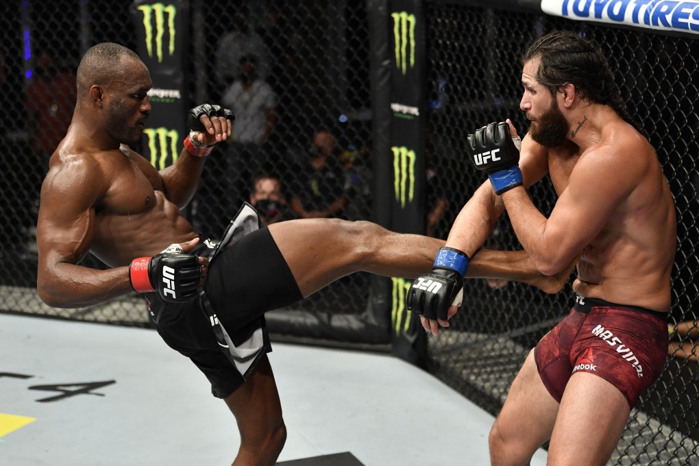 Kamaru Usman kicks Jorge Masvidal in their welterweight championship fight during UFC 251. Photos: Jeff Bottari/Zuffa LLC