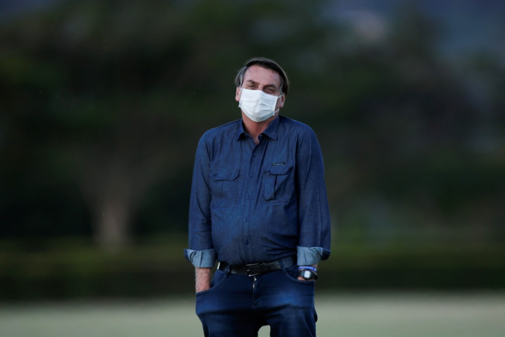 Brazil's President Jair Bolsonaro observes a flag-lowering ceremony at the Alvorada Palace in Brasilia on Wednesday. Photo: Reuters