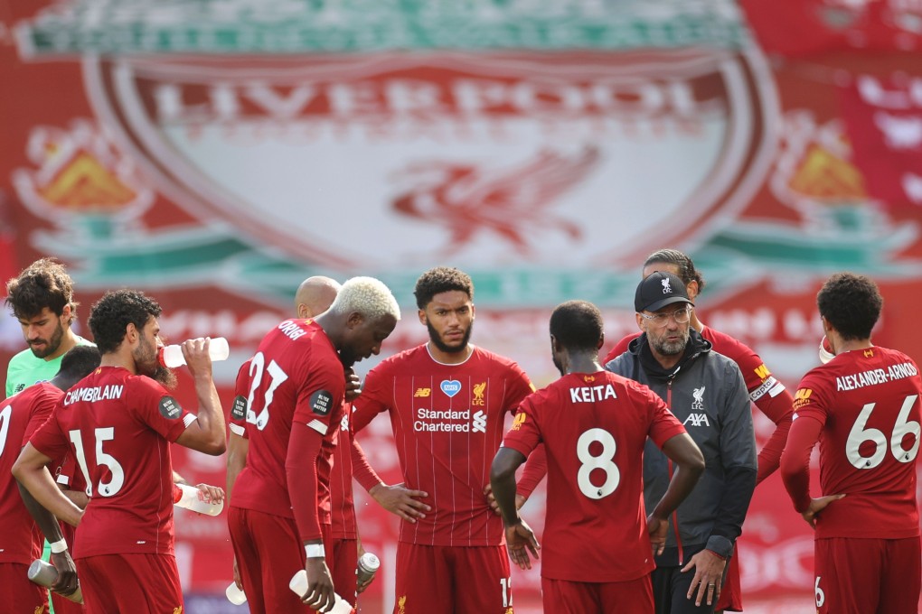 Liverpool manager Jurgen Klopp speaks to his players during a break in their match against Aston Villa at Anfield. Photo: AFP