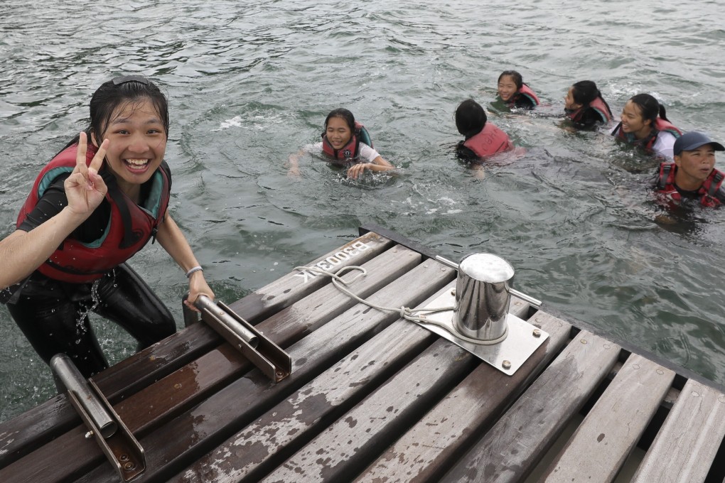 Students jump from a jetty with Outward Bound in Sai Kung. The group faces an uncertain future thanks to protests and lockdowns drying up funding. Photo: May Tse