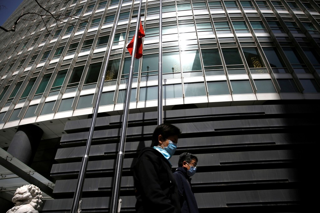 People wearing face masks walk past a bank in Beijing on April 4. Strong economic growth would discourage Chinese policymakers from rolling out bigger stimulus measures. The People’s Bank of China has already become more cautious in its injection of liquidity. Photo: Reuters