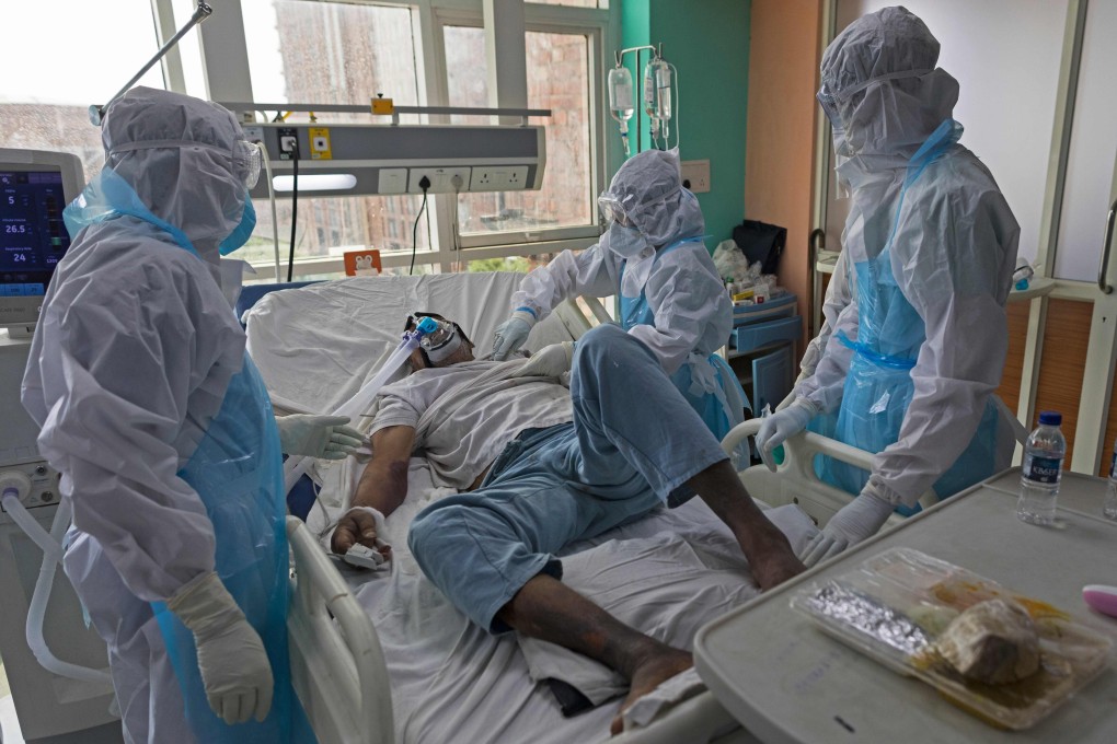 Doctors and nurses wearing protective gear look after a Covid-19 patient at a hospital’s intensive care unit in Greater Noida, India’s Uttar Pradesh, earlier this week. Photo: AFP