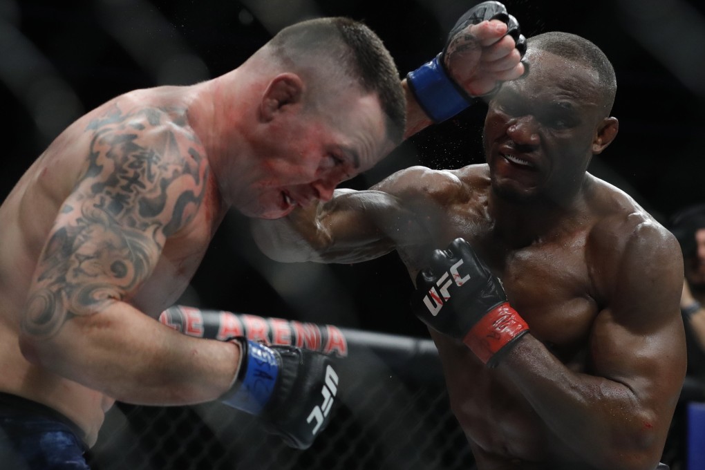 Colby Covington gets hit with a punch from welterweight champion Kamaru Usman in the fifth round of their welterweight title fight during UFC 245. Photo: AFP