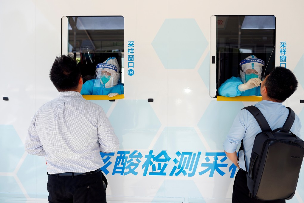 Two people are tested at the windows of a testing vehicle in Beijing on June 30. The success of group testing methods in containing Covid-19 outbreaks in Wuhan and Beijing suggest it might be a useful approach for Hong Kong given the city’s constrained testing capacity. Photo: Reuters