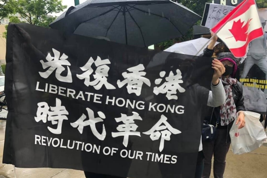 An unidentified protester holds up a “Liberate Hong Kong” flag at a rally outside the Chinese consulate-general in Vancouver on July 1. Photo: Albert Chan Wai-yip