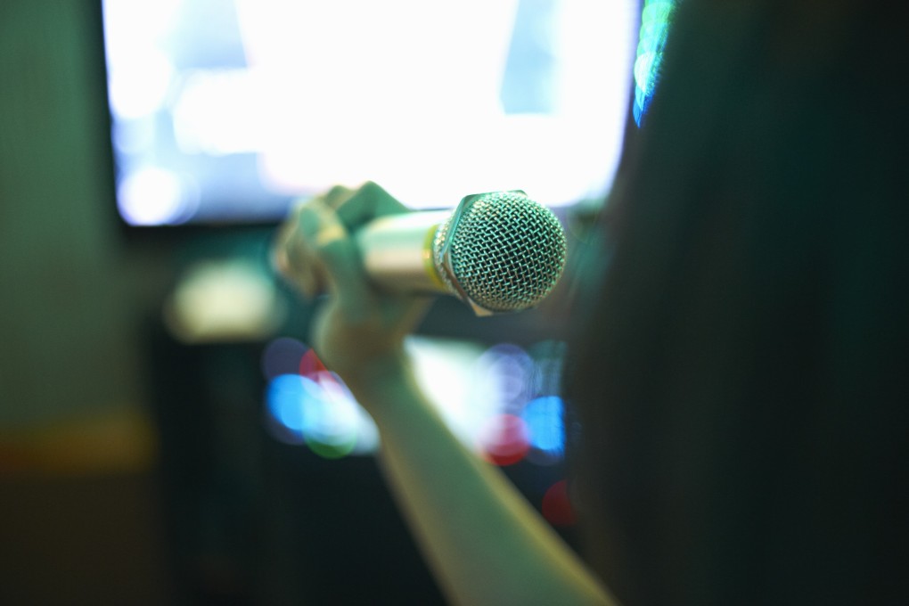 A karaoke singer performs in a karaoke lounge. A new feature allows users to sing clearly even while wearing a face mask. Photo: Handout