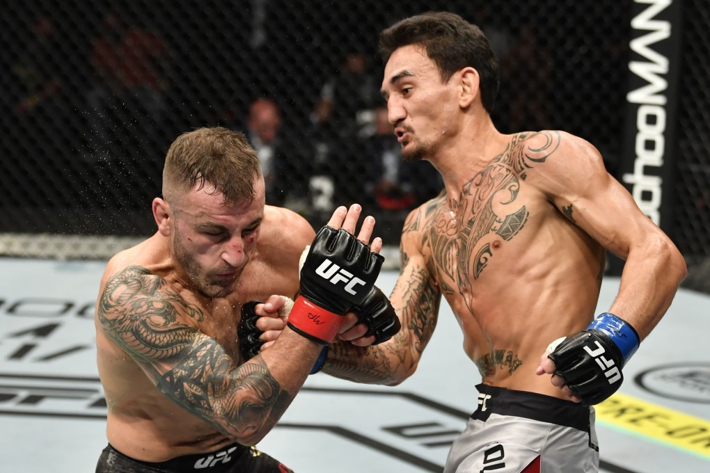 Max Holloway punches Alexander Volkanovski in their featherweight championship fight during UFC 251. Photo: Jeff Bottari/Zuffa LLC via USA TODAY Sports