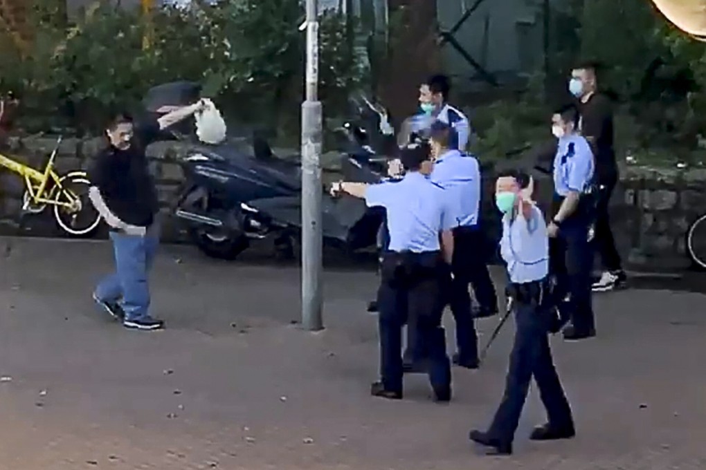 Hong Kong police confront a man wielding a kitchen cleaver on Friday in an incident that began when the man refused to wear a surgical mask on a bus as now required by law. Photo: Facebook
