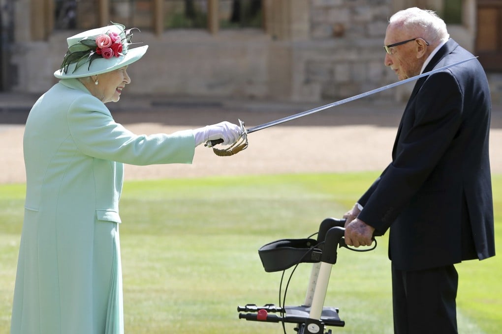 Captain Sir Thomas Moore receives his knighthood from Britain's Queen Elizabeth during a ceremony at Windsor Castle on Friday. Photo: AP