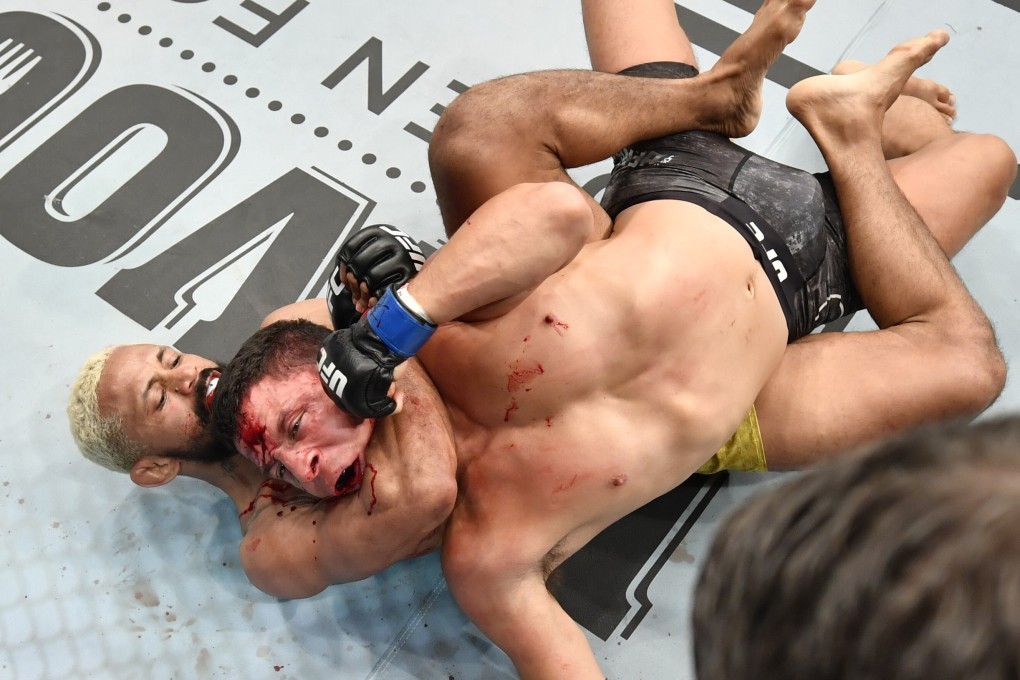 Deiveson Figueiredo secures a rear-naked choke submission against Joseph Benavidez in their UFC flyweight championship bout during the UFC Fight Night event inside Flash Forum on UFC Fight Island in Abu Dhabi. Photos: Jeff Bottari/Zuffa LLC via Getty Images