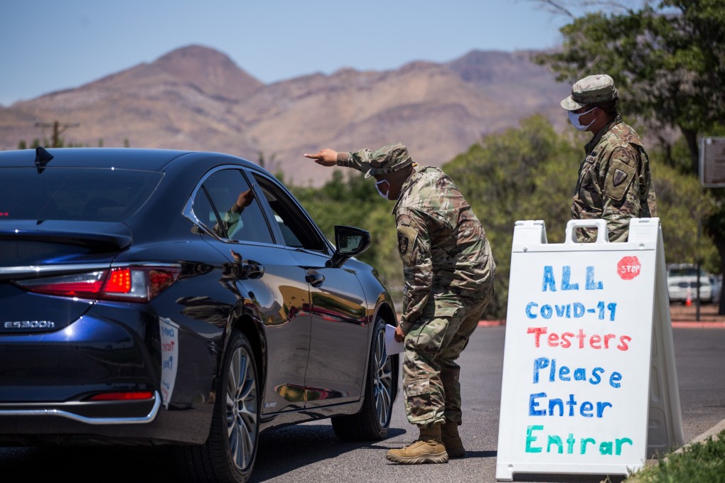 US Army personnel wearing protective masks guide residents to a drive-through Covid-19 testing site in El Paso, Texas. Photo: Bloomberg