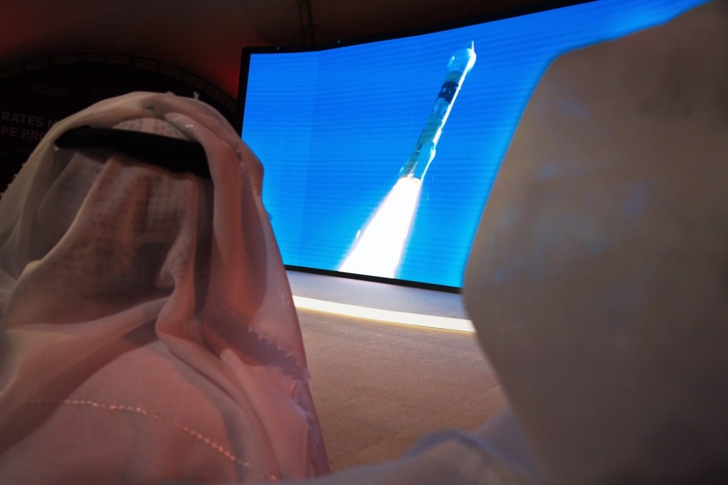 Emirati men watch the launch of the “Amal” or “Hope” space probe at the Mohammed bin Rashid Space Centre in Dubai. Photo: AP Photo