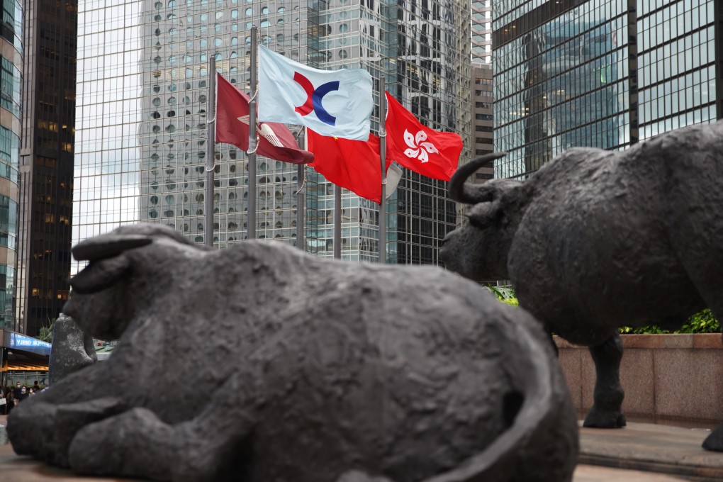 Bronze sculptures of bulls and the Hong Kong stock exchange flag at the Exchange Square in Central. Photo: Winson Wong