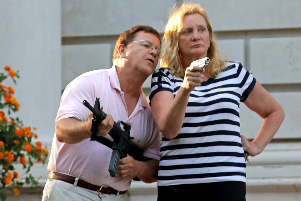 Mark and Patricia McCloskey confront protesters outside their St Louis home in June. Photo: St Louis Post-Dispatch via AP