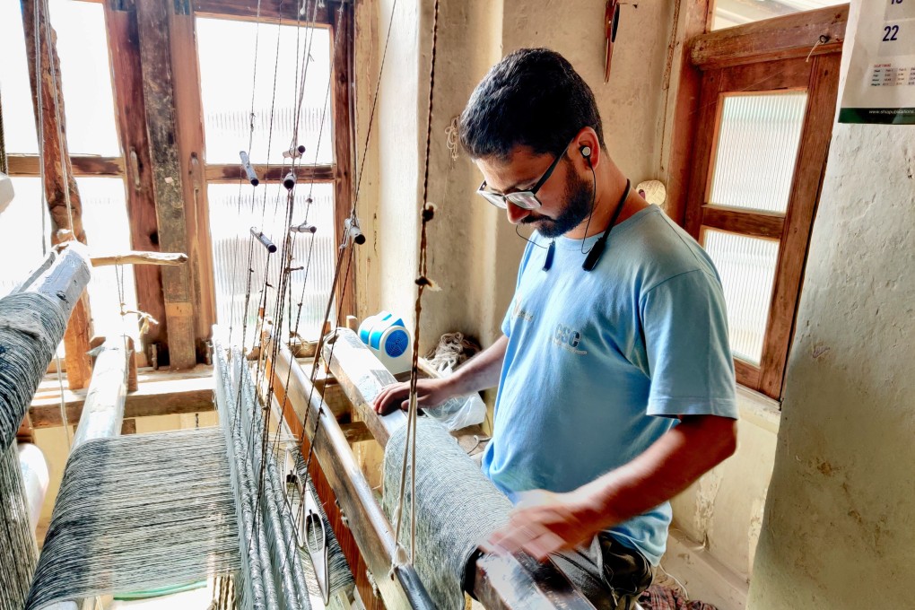 Aijaz Ahmad, 28, weaves pashmina shawls on a traditional loom at his home in central Srinagar, Kashmir, India. But he regrets ever learning the trade. Photo: Shoaib Shafi