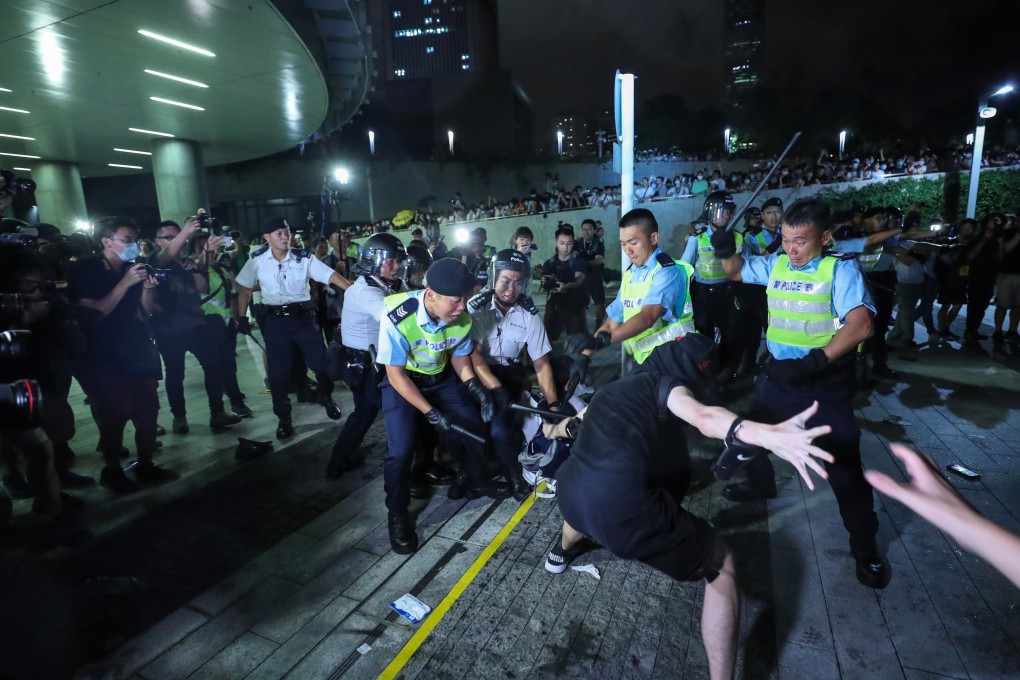Demonstrators clash with police outside the Legislative Council in Admiralty just after midnight, during a protest in June last year against the extradition bill. Photo: Sam Tsang