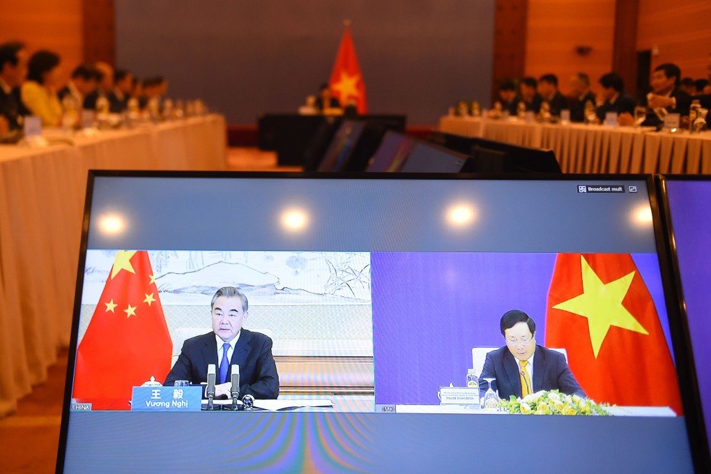 Chinese Foreign Minister Wang Yi (left) is seen during a videoconference with his Vietnamese counterpart Pham Binh Minh on Tuesday. Photo: AP