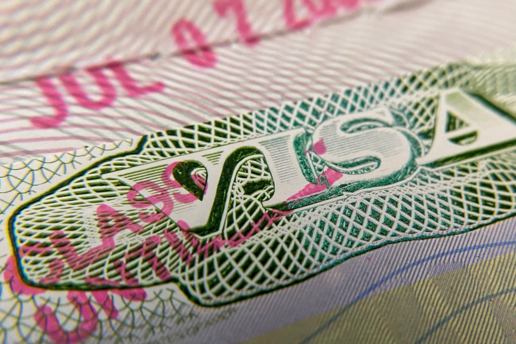 A US visa stamp is seen on a foreign passport. Photo: AFP
