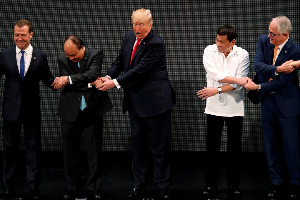 US President Donald Trump (centre) is surprised by the traditional Asean handshake at the Asean summit in Manila, Philippines, in 2017. Photo: Reuters