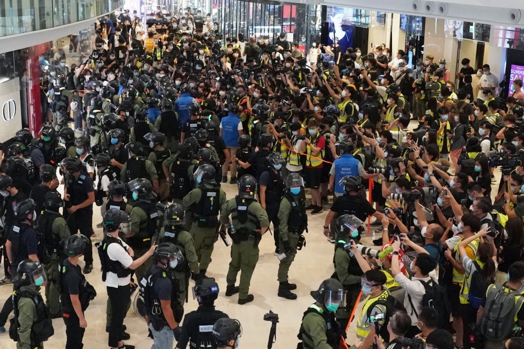 Riot police, members of the media and activists at the Yoho mall in Yuen Long on Tuesday. Photo: Felix Wong