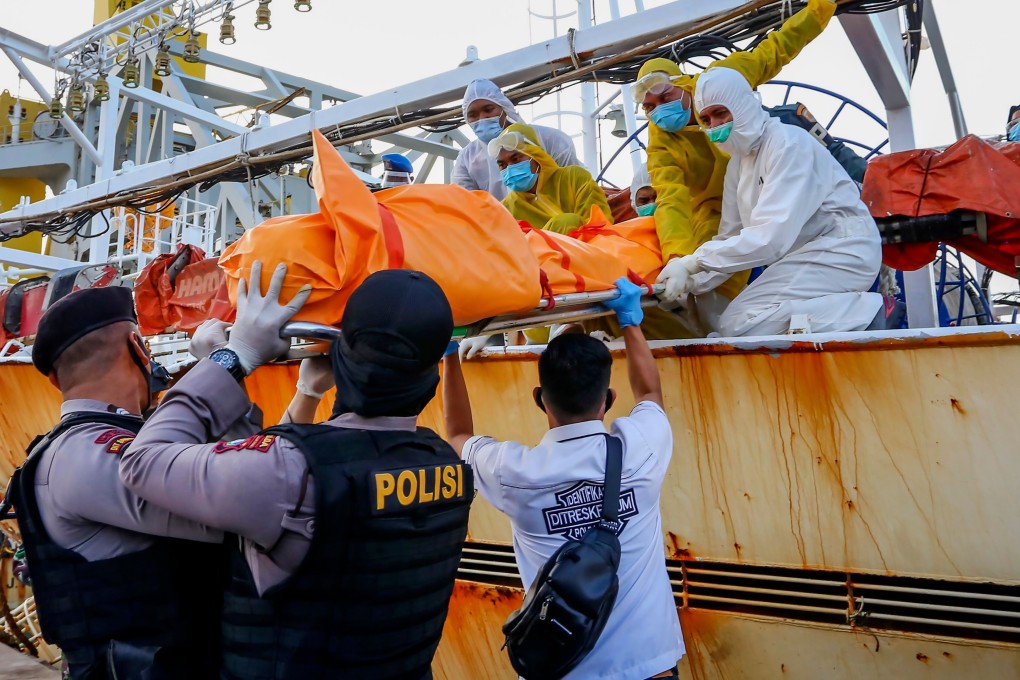 Officials transfer the body of an Indonesian crew member found following the search of a Chinese-flagged fishing vessel, at the navy port in Batam, Riau province. Photo: AFP