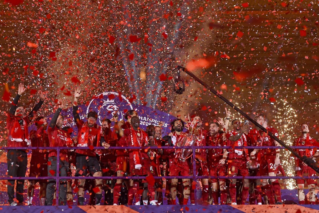 Liverpool players celebrate with the Premier League trophy after it was presented following the win over Chelsea at Anfield. Photo: AP