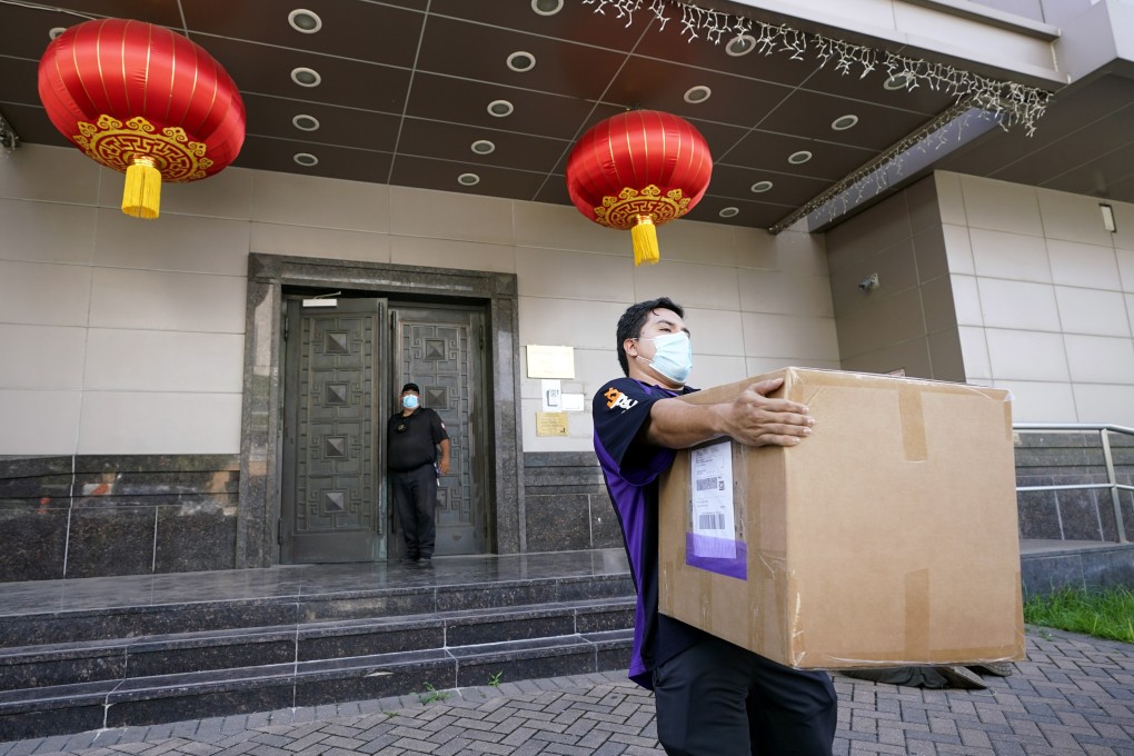 A courier company employee removes a box from the Chinese consulate in Houston on July 23. China said “malicious slander” was behind an order by the US government to close its consulate in the Texan city. Photo: AP