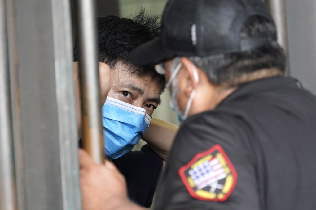 A security guard (right) talks to a man inside the Chinese consulate in Houston on Thursday. Photo: AP